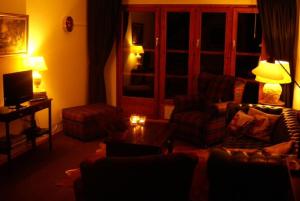 a living room with a couch and chairs and a table at Aragon lodge in Ernen