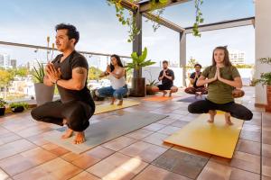 a group of people in a yoga class at BOHOSTEL in Guadalajara