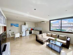 a living room with a couch and a table and a kitchen at The Villa by Albir Proper Properties in Albir