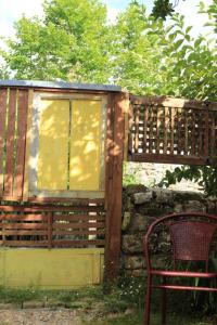 a wooden cabin with a bench and a window at La Ventanita Del Campo in La Cavada