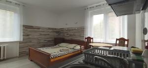 a bedroom with a bed and a brick wall at Villa Sart in Gdańsk