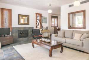 a living room with a couch and a coffee table at Casa Aguila Ibiza in Cala Vadella