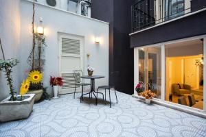 a patio with a table and chairs in a building at Deniz Suites in Istanbul