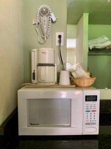 a microwave with a coffee maker on top of it at Stevenson’s Inn in Kings Beach