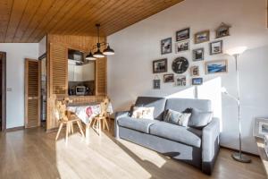 a living room with a couch and a table at Studio les Granges - Vue montage et village, Centre la Clusaz - AravisTour in La Clusaz
