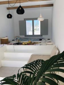 A television and/or entertainment centre at Quartano Luxury Cycladic Residence, Adults Only (13+)