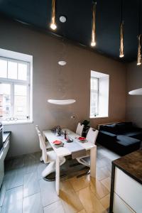 a kitchen and living room with a white table and chairs at AH Luxury Baštová 10 in Košice