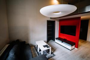 a living room with a couch and a tv at AH Luxury Baštová 10 in Košice