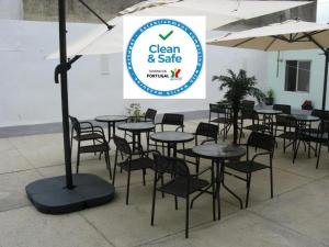 a group of tables and chairs with a sign that reads clean and safe at Hotel S. Gabriel in Porto