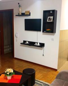 a living room with a tv on a white wall at Apartmani Tamara in Vrnjačka Banja