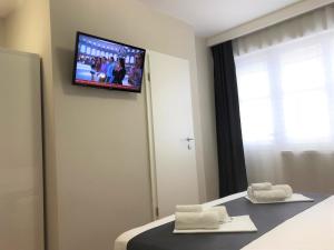 a hotel room with a television on the wall at Berulia accommodation in Brela