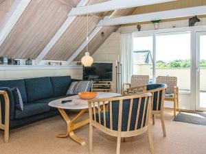 un soggiorno con divano blu e tavolo di 6 person holiday home in Ringk bing a Ringkøbing