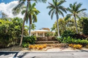 a house with palm trees in front of it at LIC Mgr - MODERN 4 BED 4 BATH VILLA - UPSCALE OCEANFRONT RESORT - INDOOR PICKLEBALL - SPEAKEASY! in Key Largo