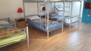 two bunk beds in a room with a wooden floor at Gite Au Pré du Mont st michel in Villiers-le-Pré