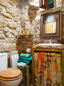 a stone bathroom with a toilet and a sink at Apartamento en Plena Naturaleza in La Cavada