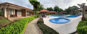 an image of a house with a swimming pool at Hotel & Villas Huetares in Playa Hermosa