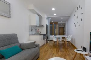a living room with a couch and a table at Playa Sanxenxo in Sanxenxo