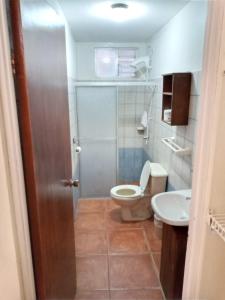 a bathroom with a toilet and a sink at Hotel & Villas Huetares in Playa Hermosa