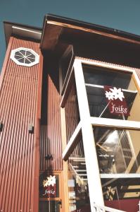 a building with a jumeico sign on it at Hosteria Foike in Ushuaia