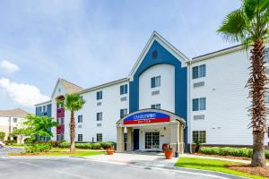 a view of a hotel with a palm tree at Candlewood Suites Savannah Airport, an IHG Hotel in Savannah