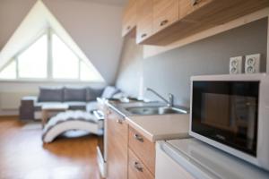 a kitchen with a sink and a living room at Apartmá Kateřina Velké Losiny in Velké Losiny