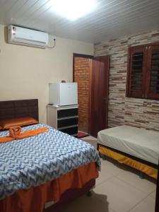 Giường trong phòng chung tại Pousada Recanto das Fontes