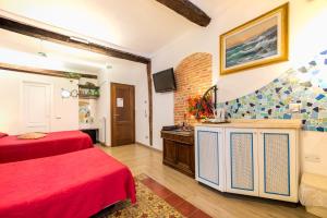 a hotel room with two beds and a tv at Sea View Suites - Francamaria Rooms in Vernazza