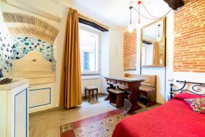 a bedroom with a bed with a piano and a window at Sea View Suites - Francamaria Rooms in Vernazza