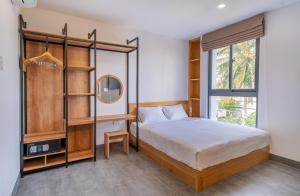 a bedroom with a bed and a mirror at Coast House Boutique Hotel in Nha Trang