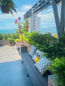 a blue bench with pillows sitting on a balcony at Coast House Boutique Hotel in Nha Trang