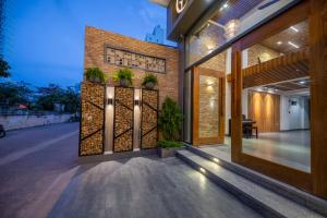 a facade of a building with plants on it at Coast House Boutique Hotel in Nha Trang