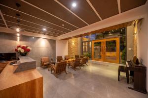 a lobby with a dining room with a table and chairs at Coast House Boutique Hotel in Nha Trang