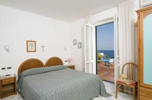 Postel nebo postele na pokoji v ubytování Hotel Gemma
