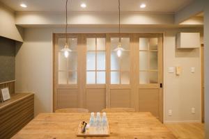 a dining room with a table with chairs and lights at ホテル天使館 久茂地 -Tenshi-Kan- in Naha