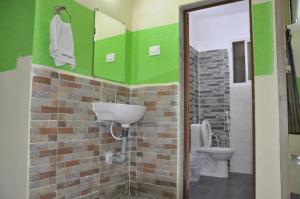 a bathroom with a sink and a toilet at Nayath Serviced Apartments in Tirupati