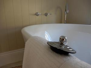 a silver object sitting on top of a white tub at The Chapel Deloraine in Deloraine