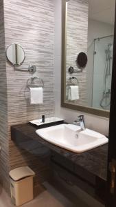 a bathroom with a sink and a mirror at Club Mahindra Mac Boutique Hotel in Bangkok +33 photos