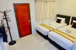 Postel nebo postele na pokoji v ubytování Vamin Resort Chiangkhan Loei วามินทร์รีสอร์ท เชียงคาน เลย