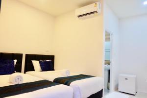 מיטה או מיטות בחדר ב-Vamin Resort Chiangkhan Loei วามินทร์รีสอร์ท เชียงคาน เลย