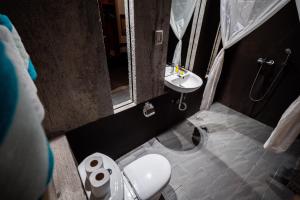 a small bathroom with a toilet and a sink at Frendz Hostel El Nido in El Nido