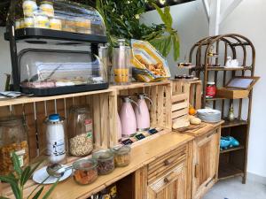a wooden shelf with food on top of it at Hôtel Mademoiselle in Juan-les-Pins