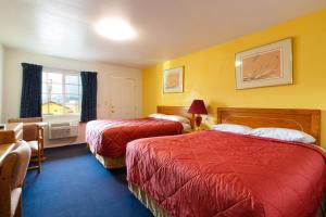 a hotel room with two beds and a window at Roseburg Inn in Roseburg