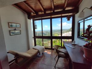 a room with a table and chairs and a large window at El hogar de Lucía in Casares