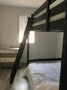 a bedroom with a bunk bed and a desk at Le Sableau in Beauvoir-sur-Mer