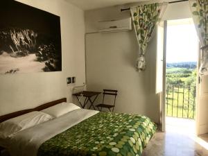 a bedroom with a bed and a window with a view at B&B Il Secolo Breve in Ortona
