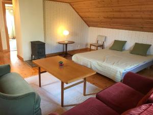 a room with a bed and a table and a couch at Högetorp in Oskarshamn