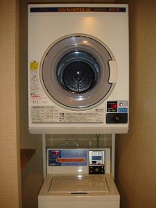 a washer and dryer in a hotel room at Ryokan Mikawaya in Tokyo