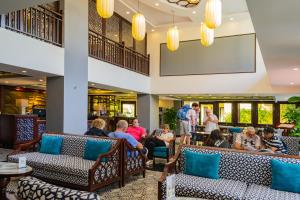 a group of people sitting in the lobby of a hotel at Silkotel Hoi An in Hoi An
