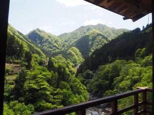 a view of a valley from a balcony at Guesthouse Nishiki in Chichibu