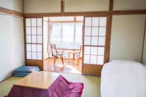 Ένα ή περισσότερα κρεβάτια σε δωμάτιο στο Ryokan Fuji Heights